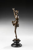 Right side view of raised leg ballerina bronze statue with a flowing skirt