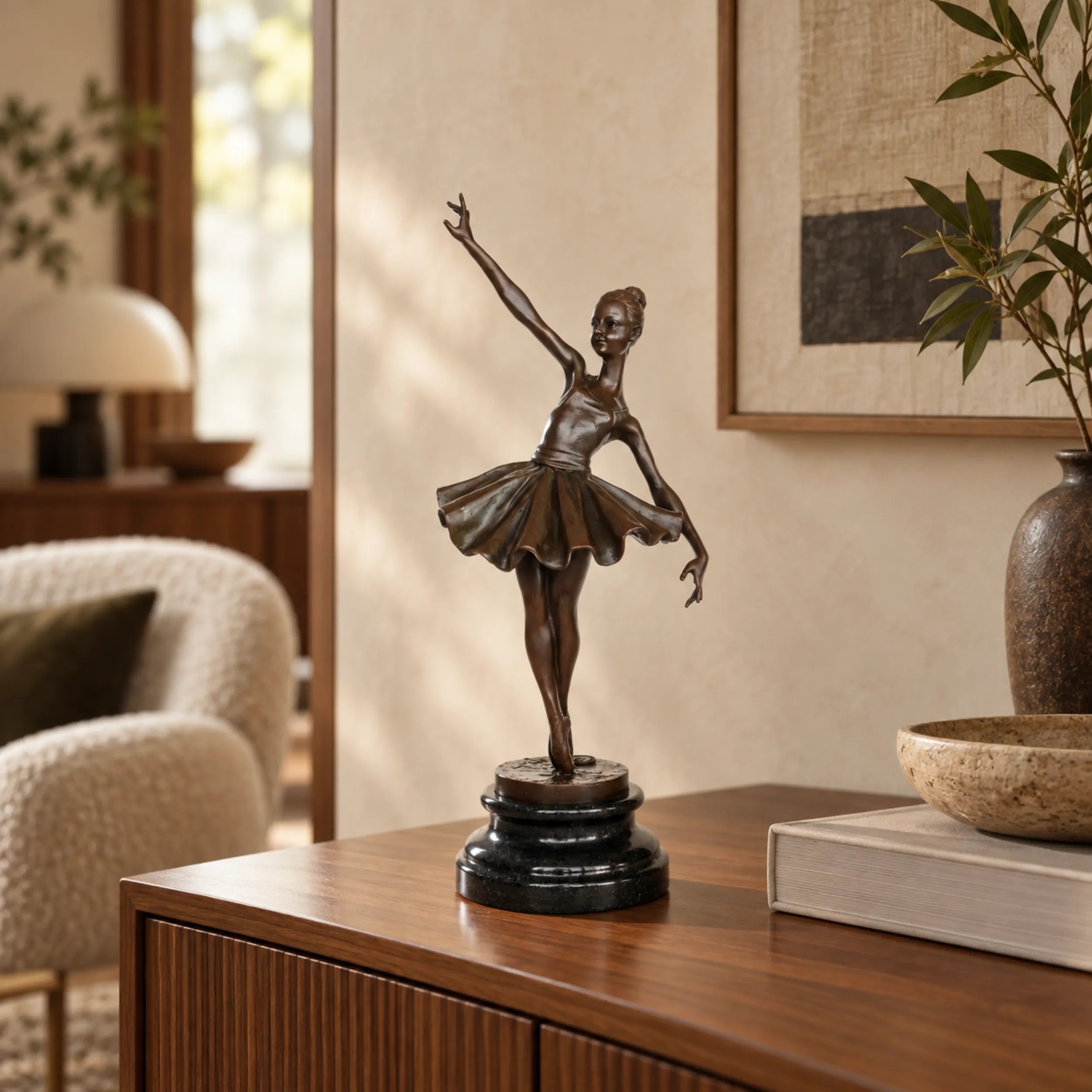 Reaching ballerina bronze sculpture displayed on an elegant console table in a modern living room