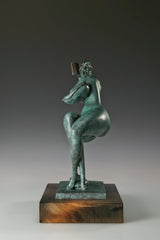 Right side view of a green patina bronze reading woman sculpture on a rectangular wooden base