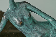Close-up of sculpted female torso and handcrafted green bronze patina