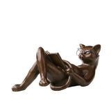 Reclining reading cat bronze sculpture wearing glasses and holding a book