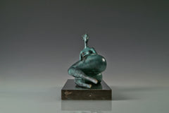 End view of reclining bronze female figure on a rectangular base