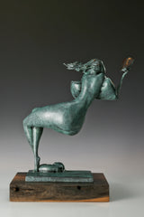 Rear view of an abstract reclining woman bronze sculpture showing her curved figure and flowing hair