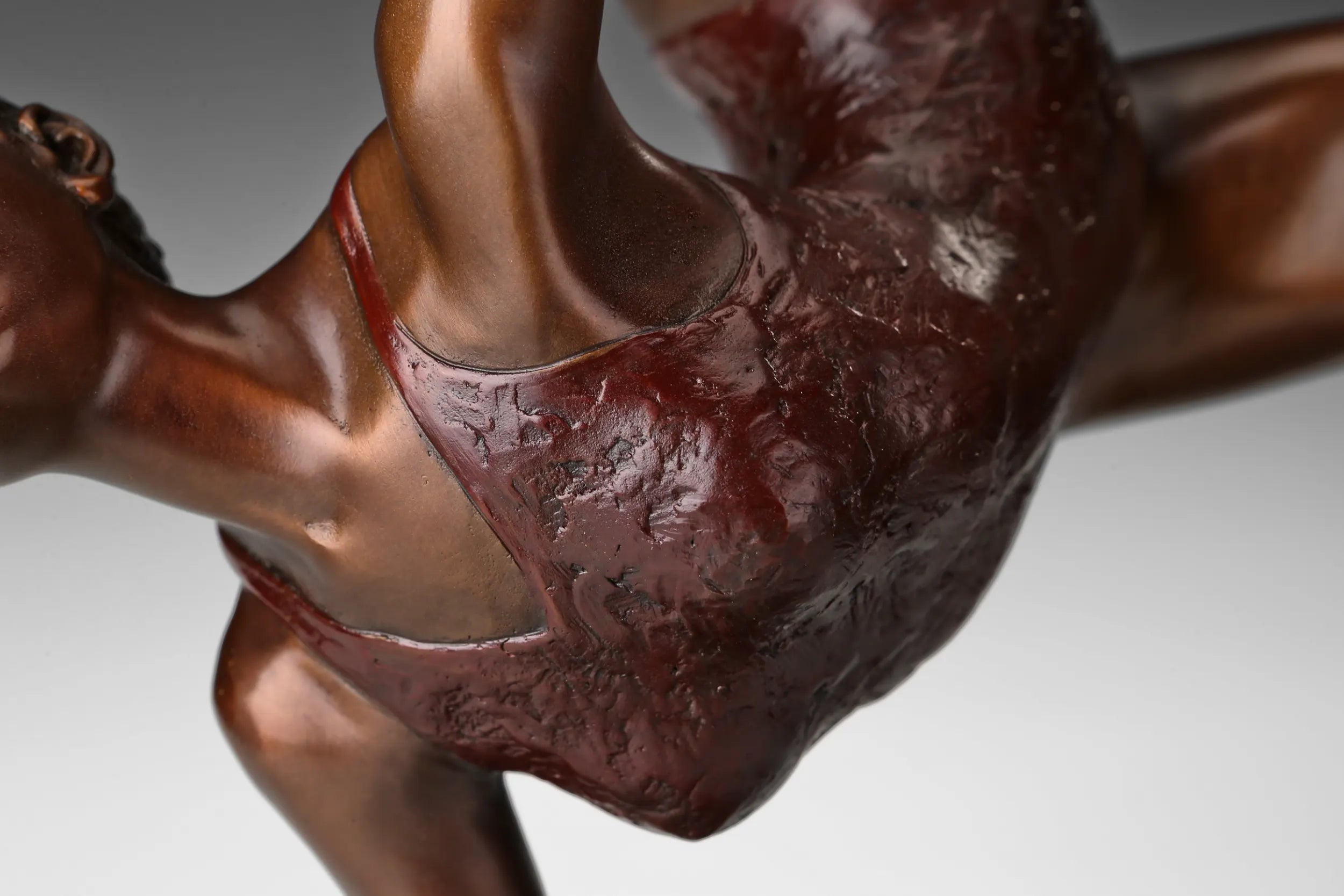 Detailed textured costume and warm bronze patina on the ribbon ballet dancer sculpture