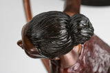 Detailed sculpted hair bun on the bronze ballet dancer figure