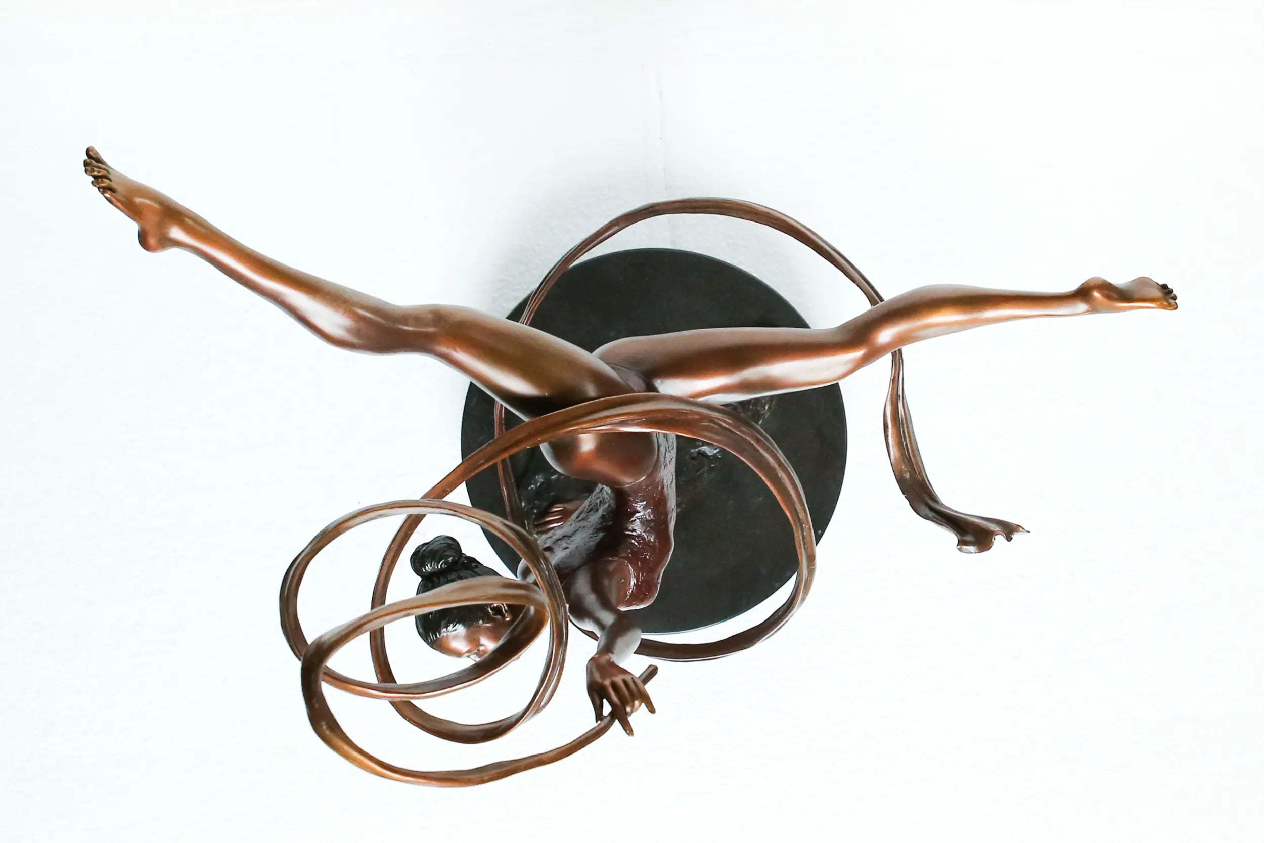 Top view of ribbon ballet dancer bronze sculpture showing the spiral ribbon and extended legs