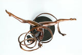 Top view of ribbon ballet dancer bronze sculpture showing the spiral ribbon and extended legs
