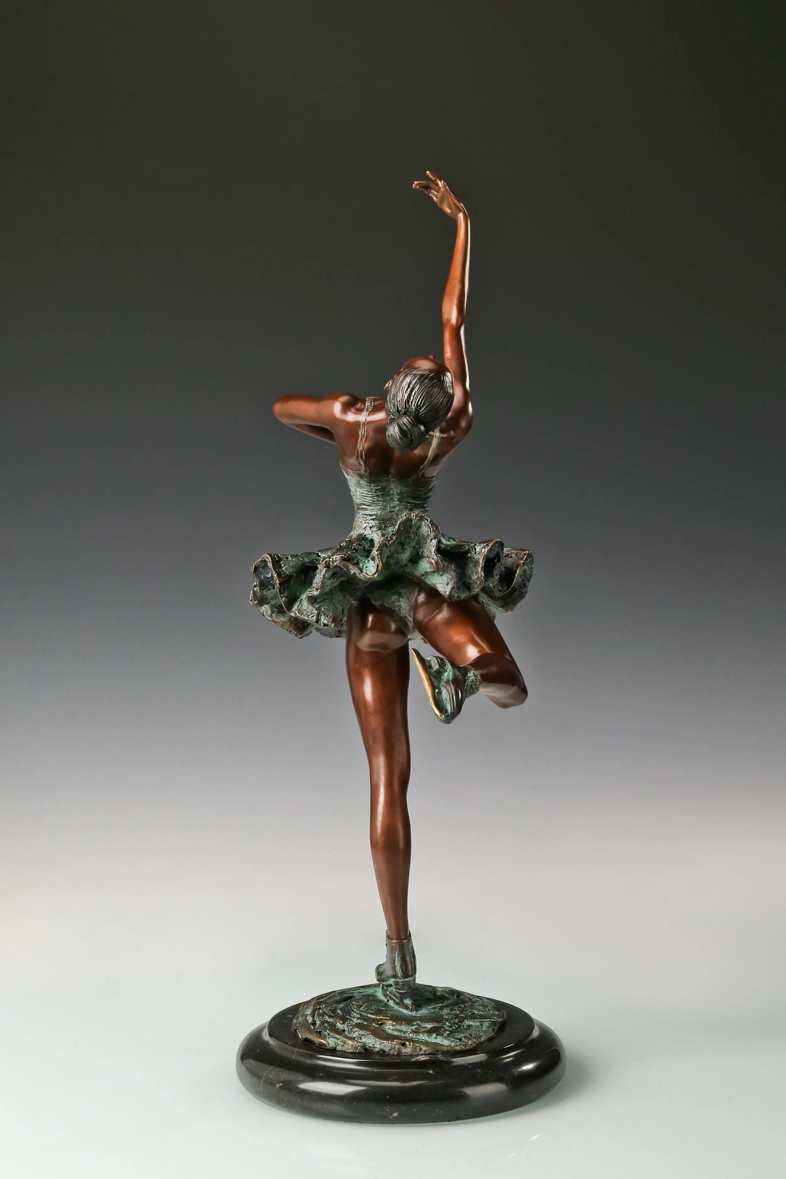 Back view of roller skating ballerina bronze sculpture showing the flowing skirt