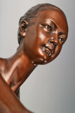 Close-up of bronze roller skating ballerina showing her upward gaze and sculpted hairstyle