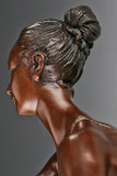 Close-up of bronze roller skating ballerina showing her upward gaze and sculpted hairstyle