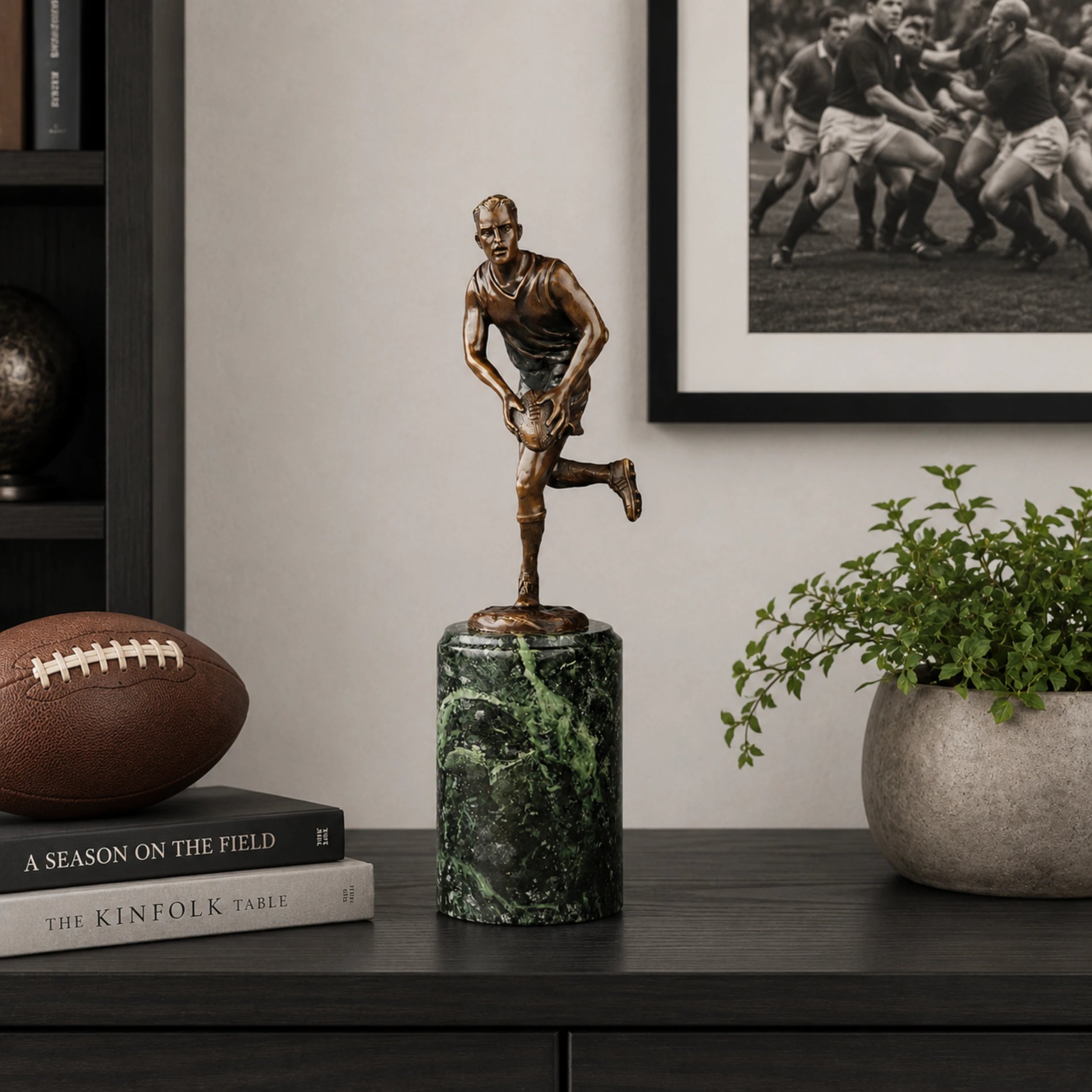 Running Back Football Bronze Sculpture displayed in a modern interior