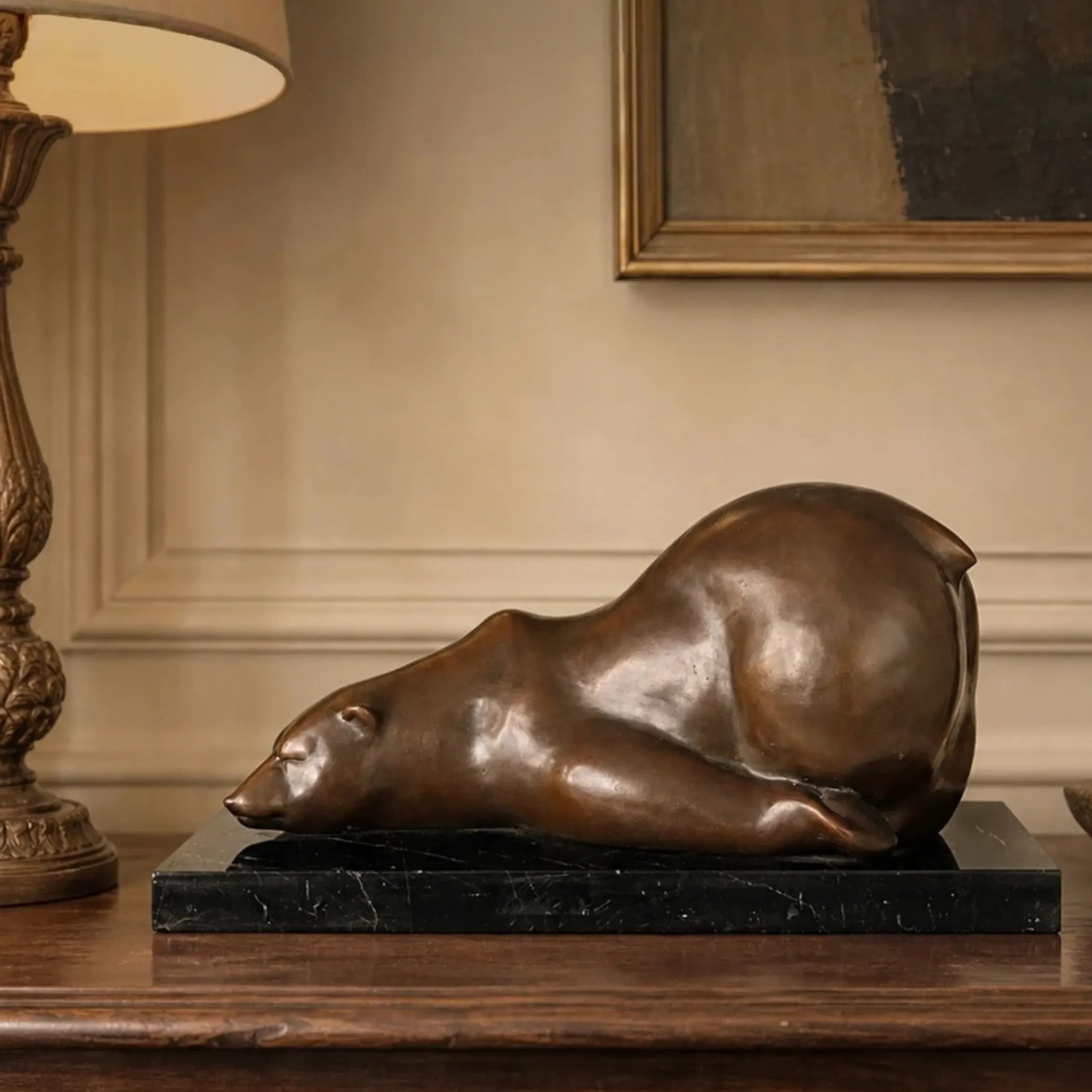 Sleeping polar bear bronze sculpture displayed in a warm modern interior