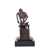 thinking pose skull statue