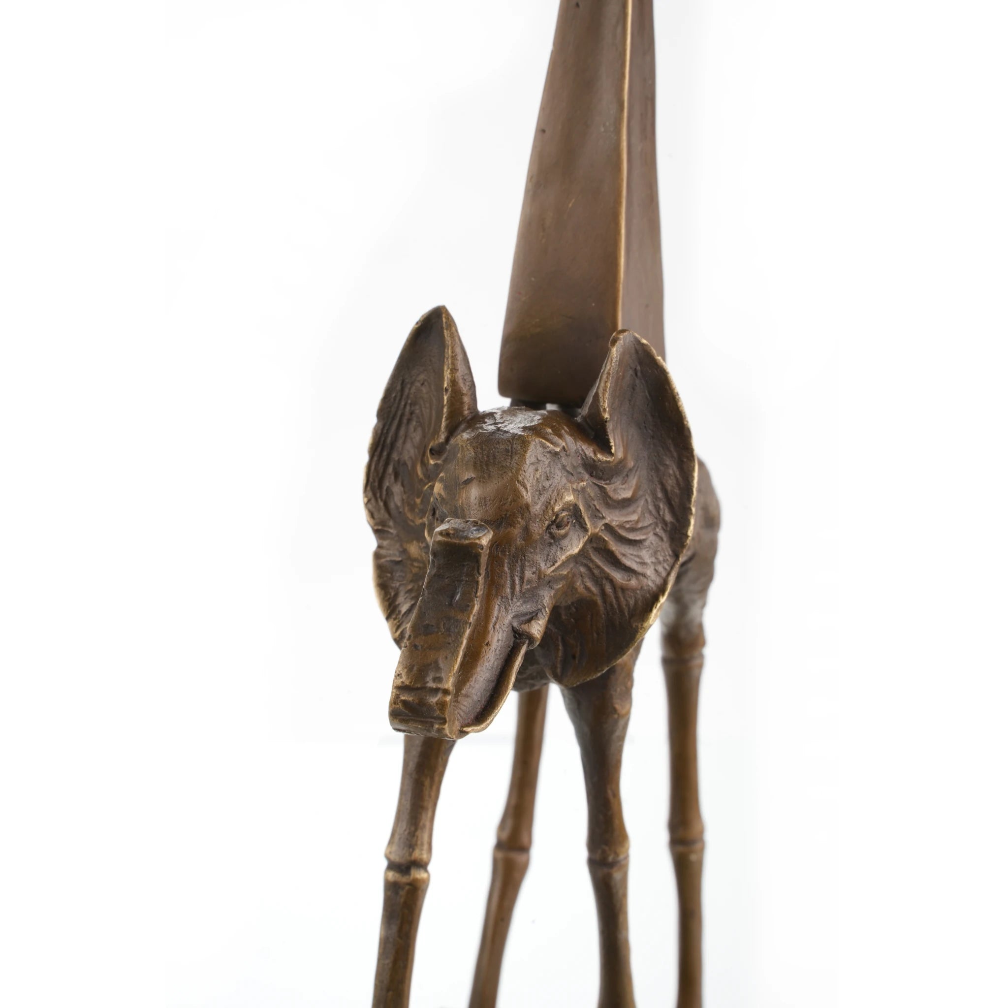 this bronze elephant on stilts sculpture features elongated legs and an obelisk motif. A striking surrealist art piece for collectors and modern interiors.