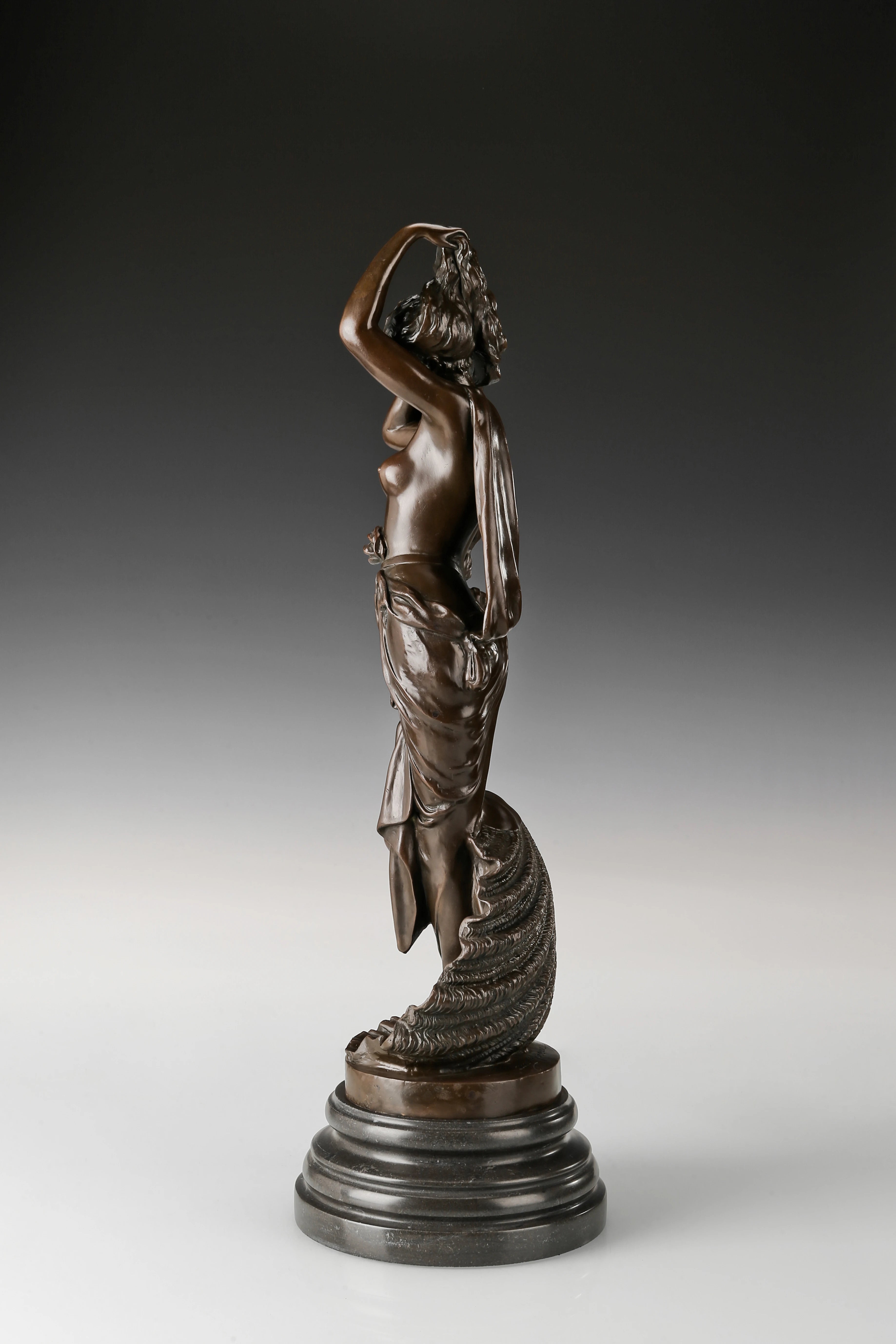 Left side view of classical Venus bronze sculpture with flowing fabric and feminine form