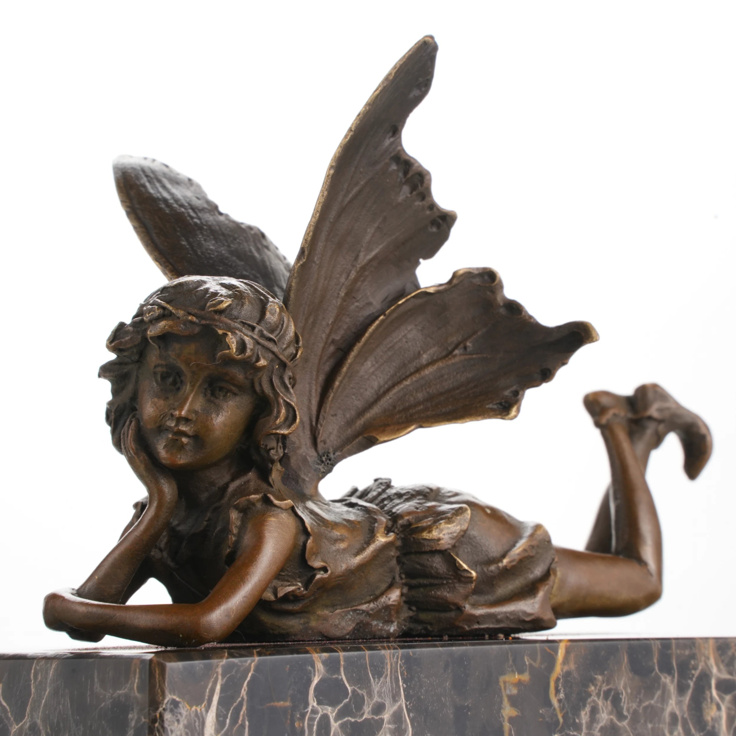 Whimsical bronze reclining fairy statue with butterfly wings on gold-veined marble base, magical fantasy art for bedroom decor.