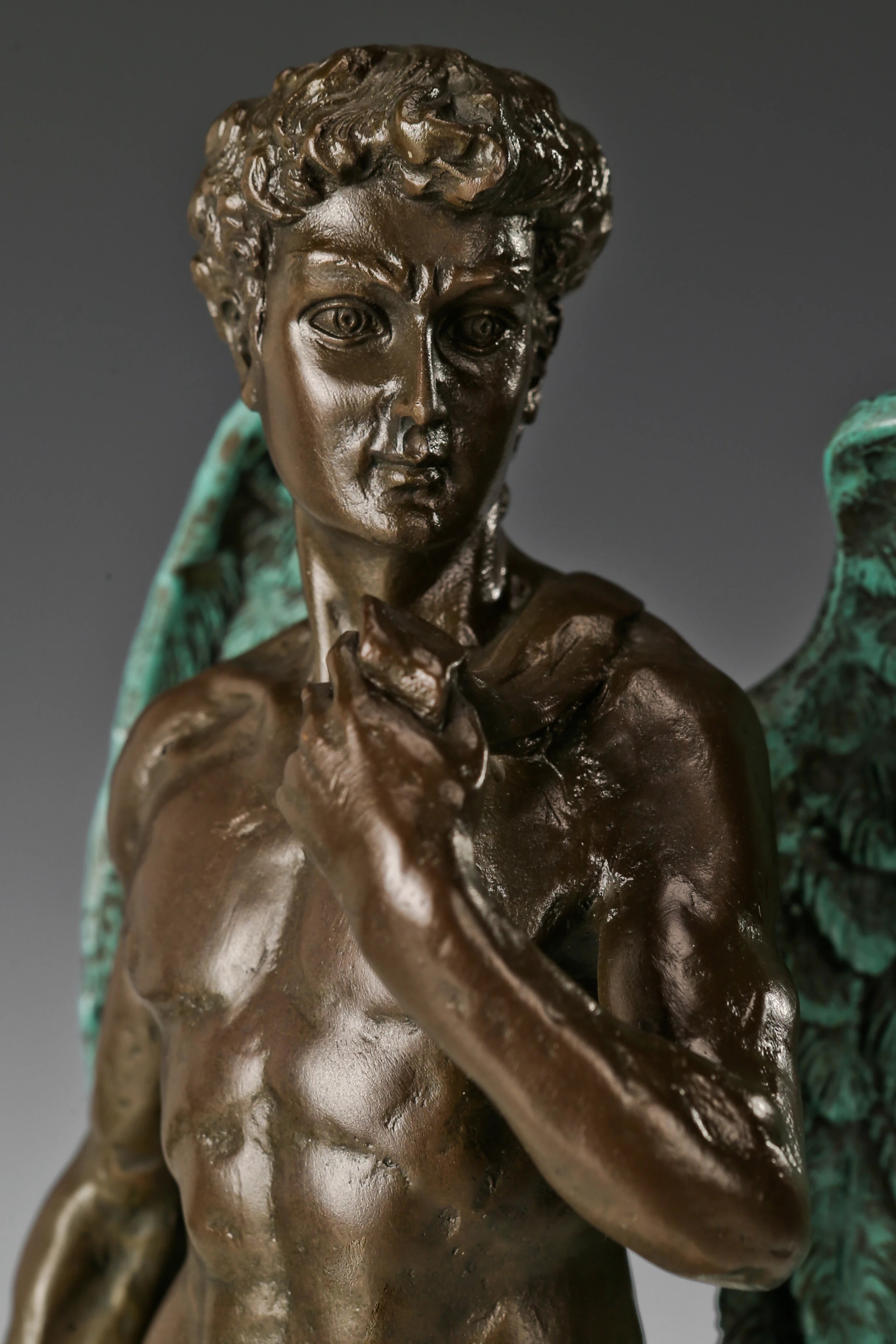 Close-up detail of handcrafted bronze male figure sculpture