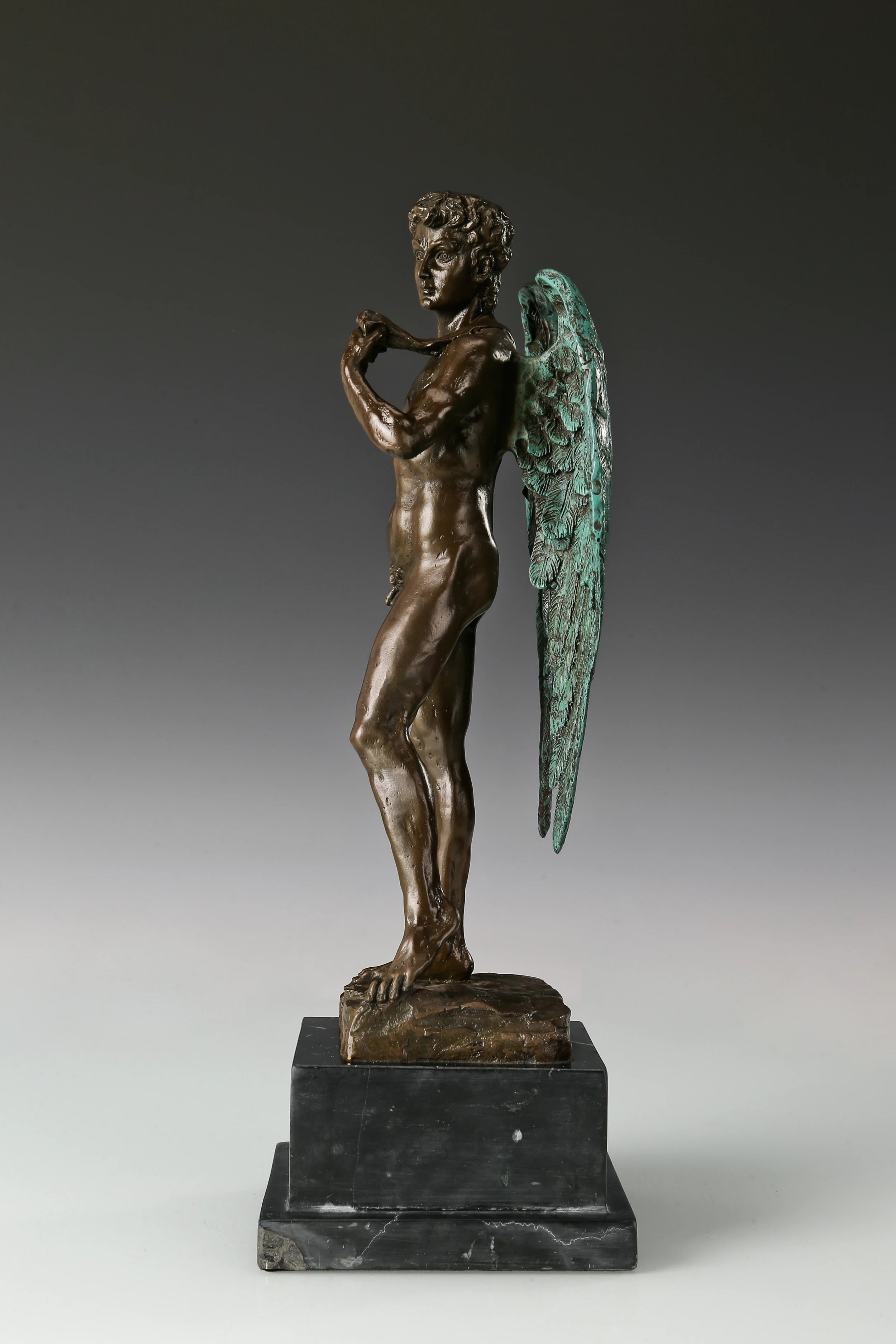 Side view of Winged David bronze sculpture showing detailed wings