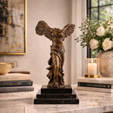 Winged Victory of Samothrace bronze statue with outstretched wings, Greek goddess Nike statue with wind-swept drapery on tiered black marble base, loss wax casting classical art.