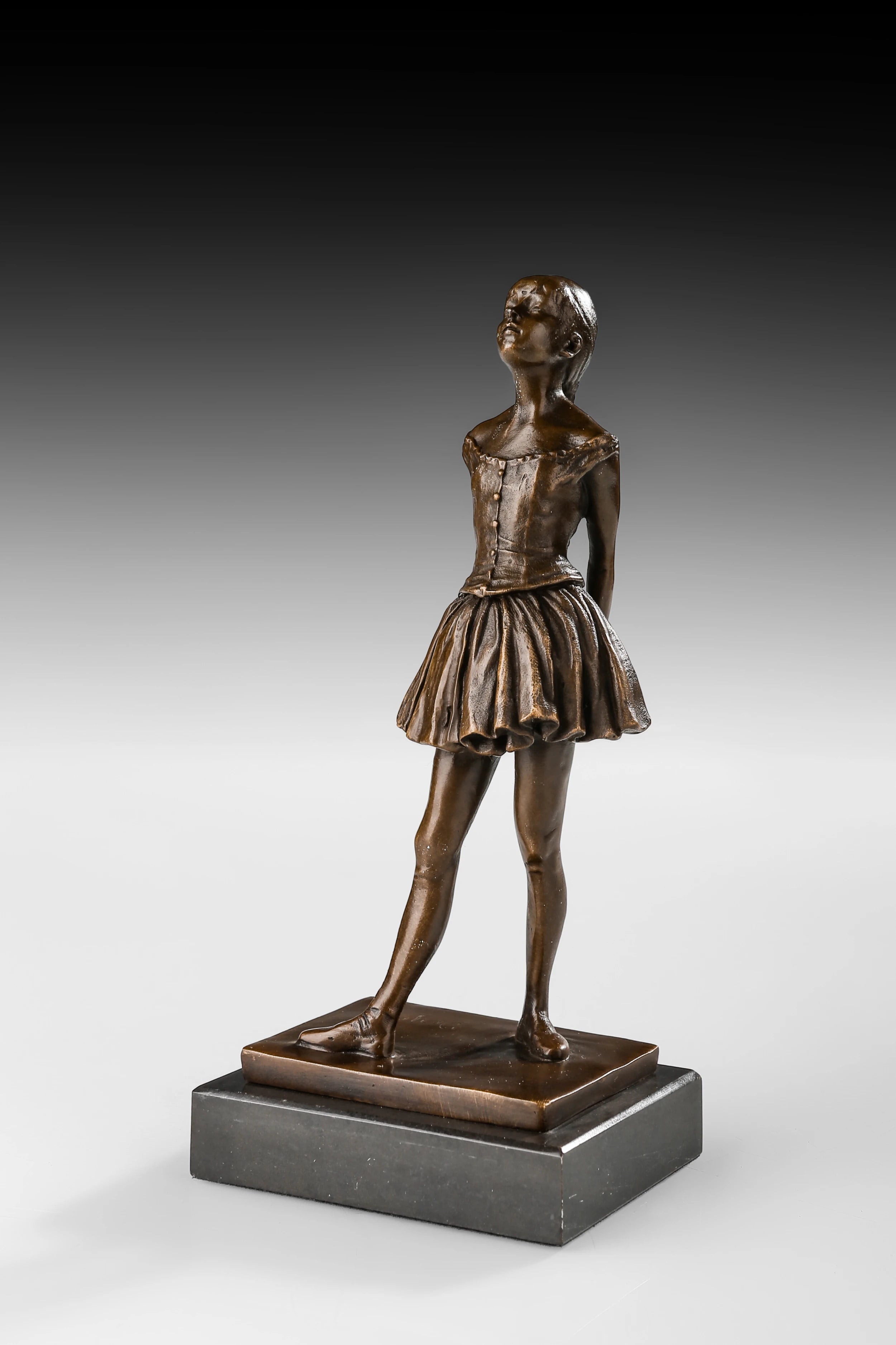 Angled view of bronze student girl statue showing poised posture and pleated skirt