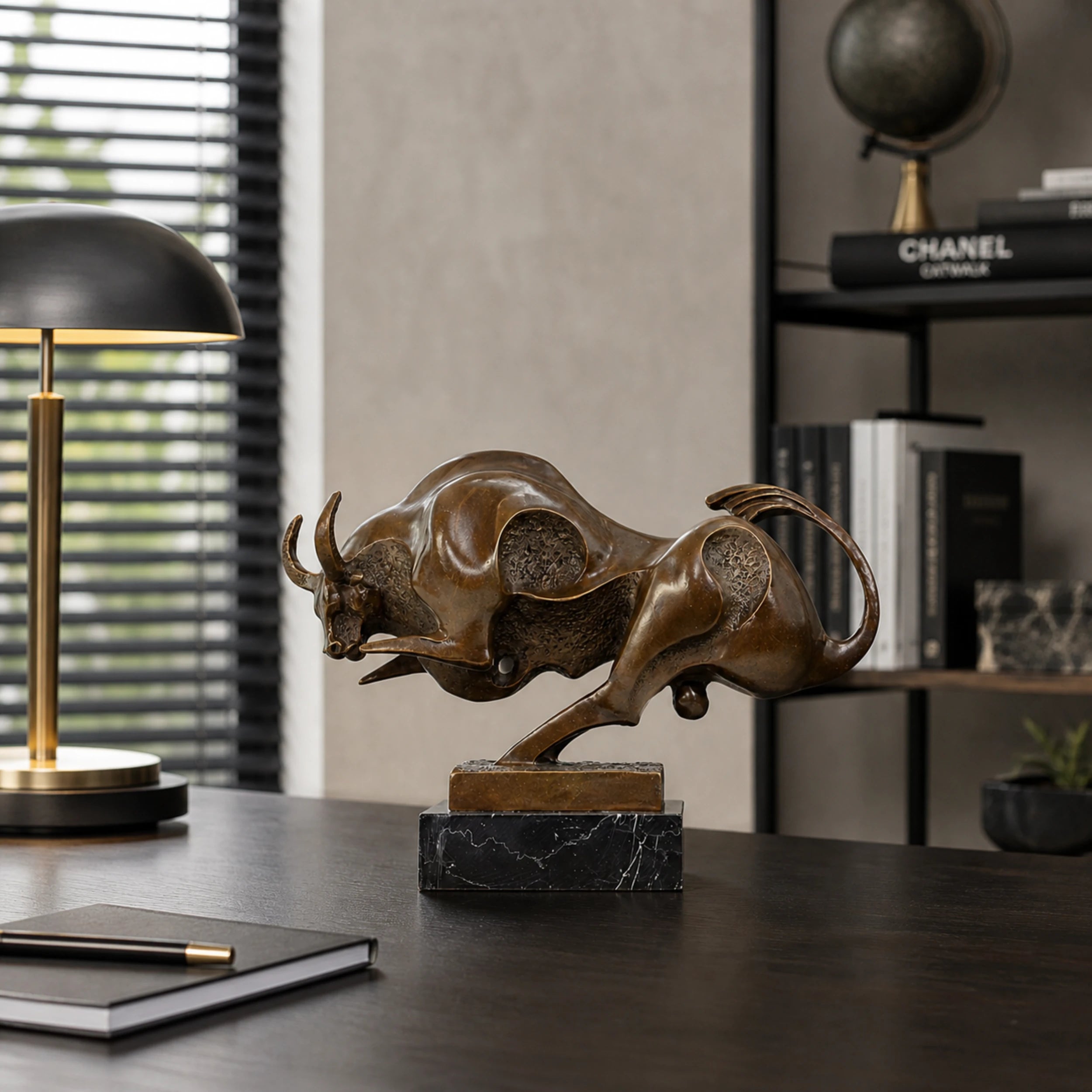 Contemporary abstract bronze charging bull sculpture with polished curves and textured voids, modern geometric animal statue on black marble base, loss wax casting fine art.