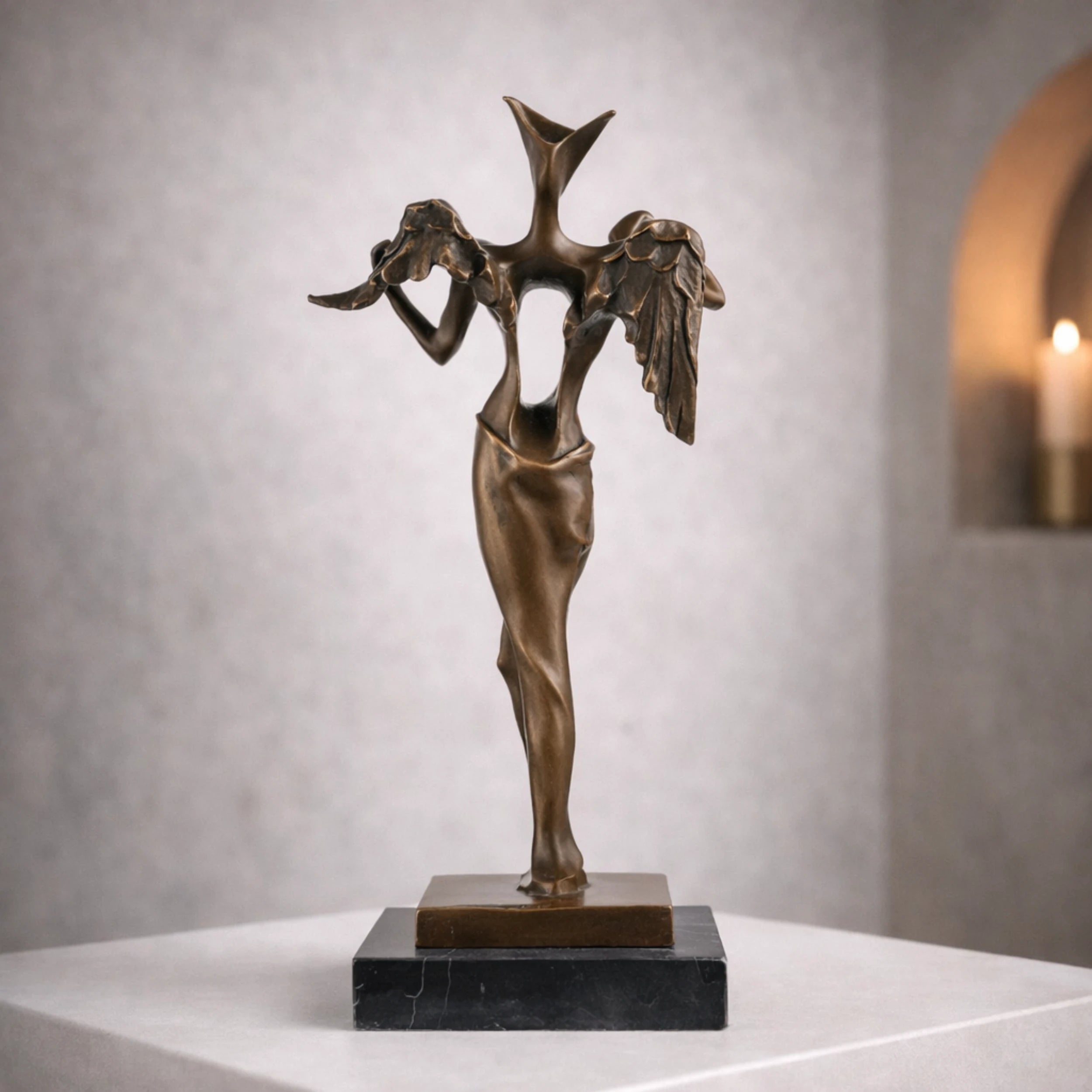 Abstract surreal bronze angel sculpture with geometric head and hollow form. A striking contemporary artwork exploring identity, faith, and form.