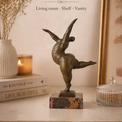Abstract bronze female sculpture in a graceful dance pose on marble base, modern home decor accent
