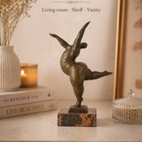 Abstract bronze female sculpture in a graceful dance pose on marble base, modern home decor accent