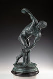 Classical Discobolus bronze sculpture of a discus thrower in a coiled pose, realistic ancient Greek athlete statue on tiered black marble base, loss wax casting fine art.