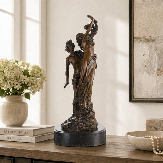 Apollo and Daphne bronze sculpture showing transformation into laurel tree, classical Greek mythology statue on oval black marble base, loss wax casting fine art.
