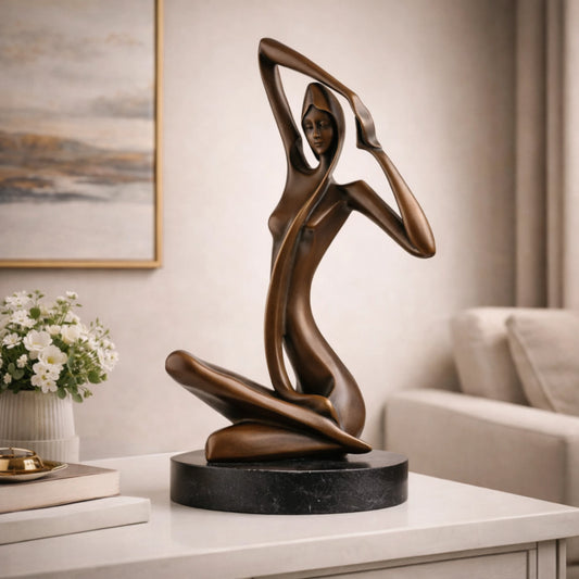 Art Deco bronze sculpture of a kneeling woman with raised arm and veil, stylized female figure on round black marble base, loss wax casting abstract art.