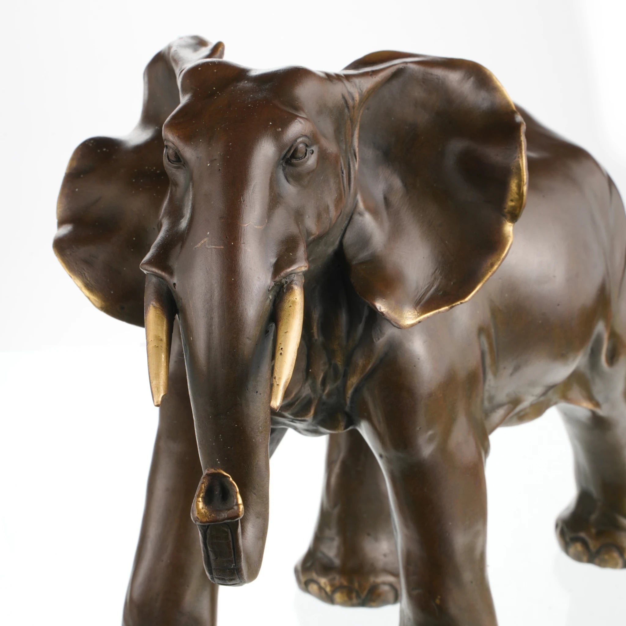Majestic African elephant bronze statue featuring rich patina and polished highlights. A powerful wildlife sculpture symbolizing strength, wisdom, and prosperity.