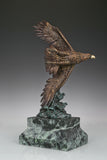 Bronze eagle sculpture with wings spread, capturing a powerful takeoff moment. A bold statue symbolizing strength, freedom, and ambition.