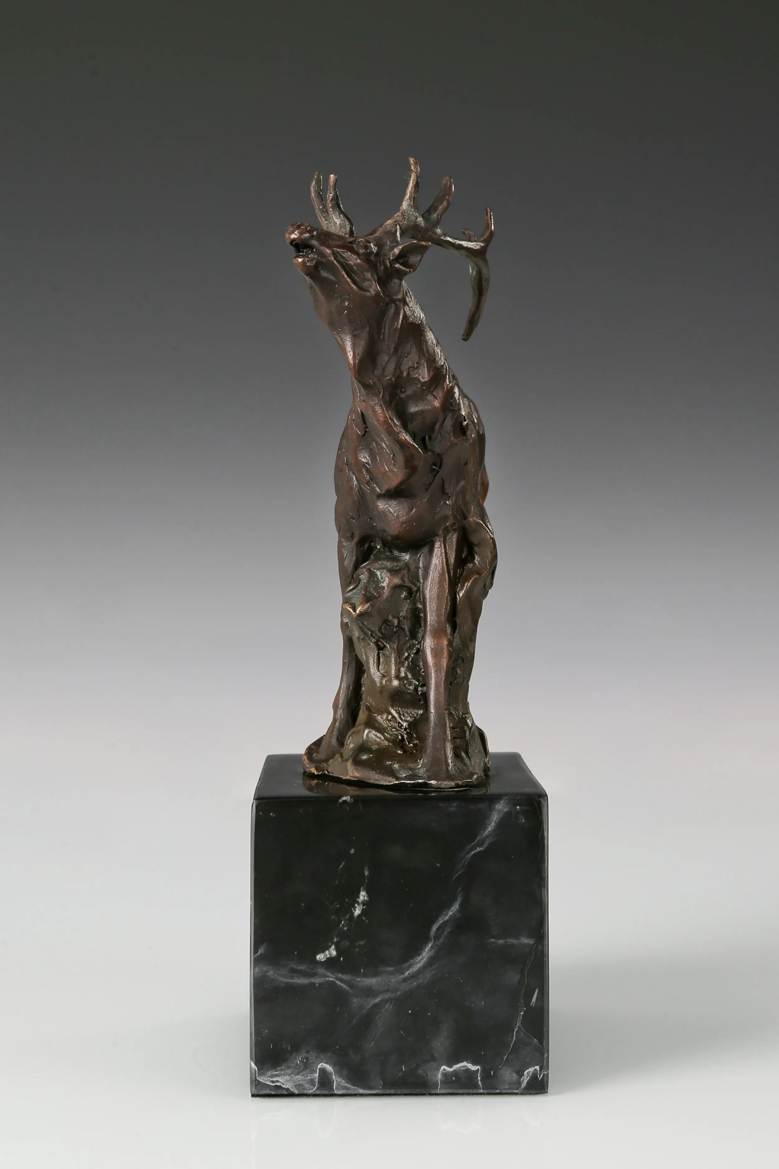 Handcrafted bugling elk bronze sculpture with large branching antlers and marble base, ideal for offices, studies, cabins, lodges and wildlife-inspired interiors.