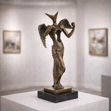 Surrealist bronze angel sculpture with hollow torso and geometric head, abstract winged statue on black marble base, loss wax casting avant-garde art.