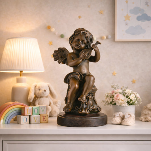 Charming bronze cherub statue playing mandolin, seated putto with lute on scroll-carved pedestal, loss wax casting musical art on dark marble base.