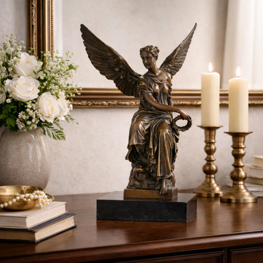 Classical bronze goddess of victory statue seated with wings and laurel wreath, winged angel Nike sculpture on black marble base, loss wax casting achievement art.