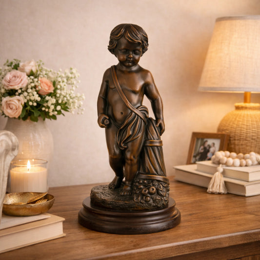 Classical bronze putto statue with overflowing cornucopia fruit, curly-haired cherub sculpture on stepped black marble base, loss wax casting harvest art.