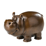 Cute handcrafted bronze cow sculpture with a cartoon-inspired design for modern home decor.