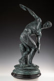 Classical Discobolus bronze statue of a discus thrower in a coiled pose, realistic ancient Greek athlete statue on tiered black marble base, loss wax casting fine art.