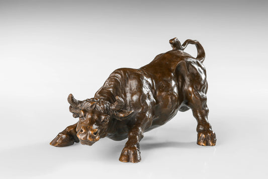 Dynamic charging bull bronze sculpture in low attack pose