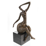 Elegant abstract bronze sculpture of a seated female figure with flowing pose and golden floral details. A refined statement piece for modern interiors.
