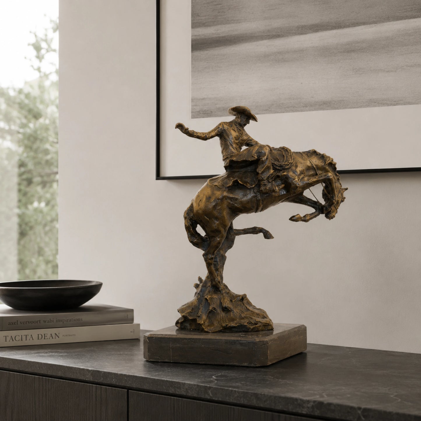 Bronze reproduction of Frederic Remington's Broncho Buster statue, cowboy riding a bucking horse on black marble base, loss wax casting fine art.