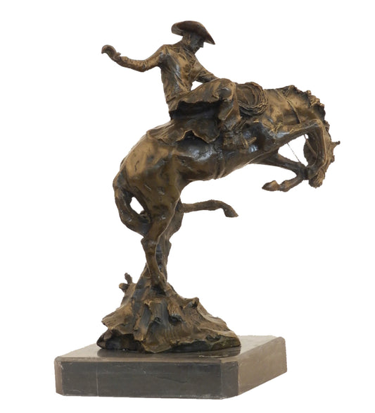 Bronze reproduction of Frederic Remington's Broncho Buster statue, cowboy riding a bucking horse on black marble base, loss wax casting fine art.