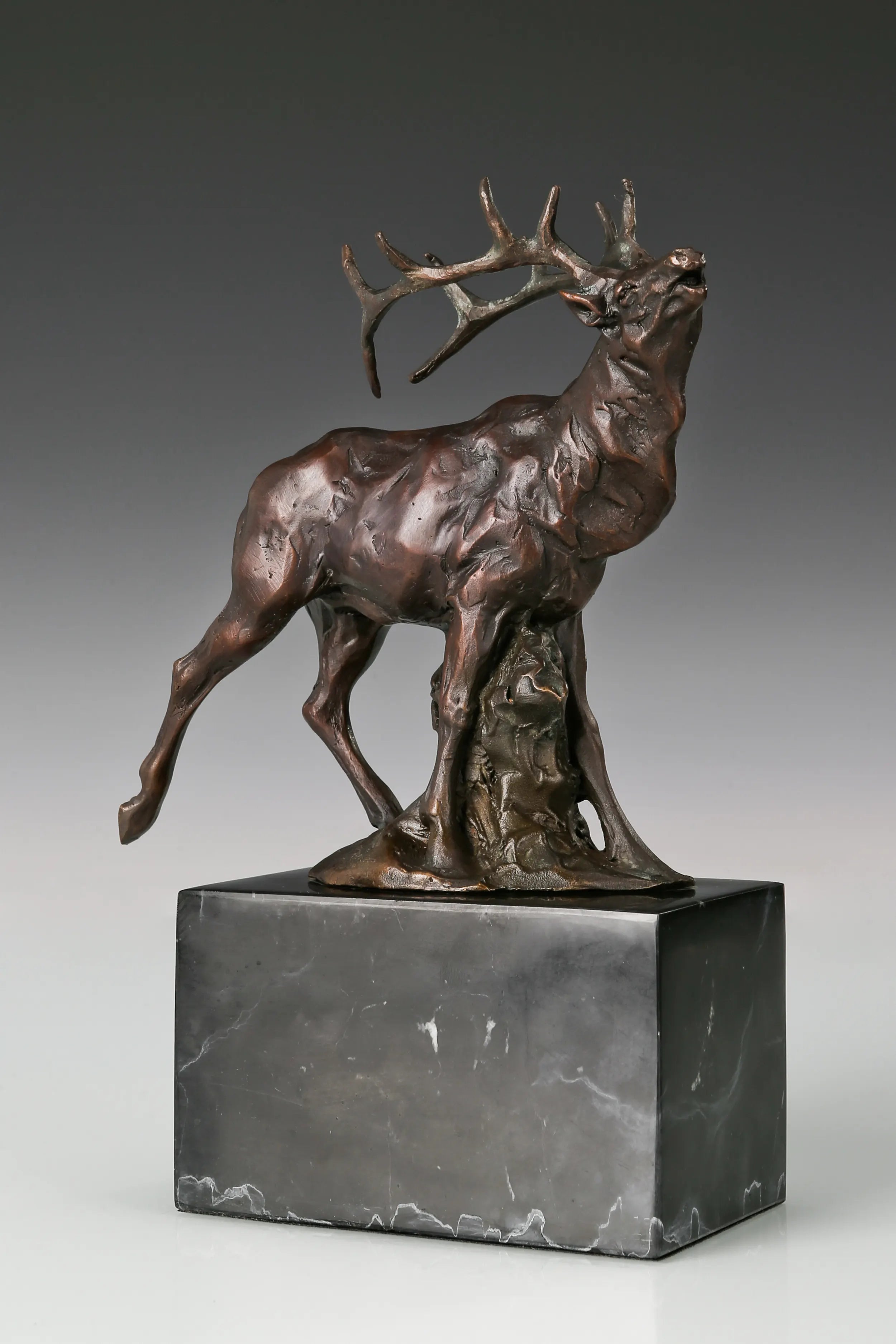 Handcrafted bugling elk bronze sculpture with large branching antlers and marble base, ideal for offices, studies, cabins, lodges and wildlife-inspired interiors.