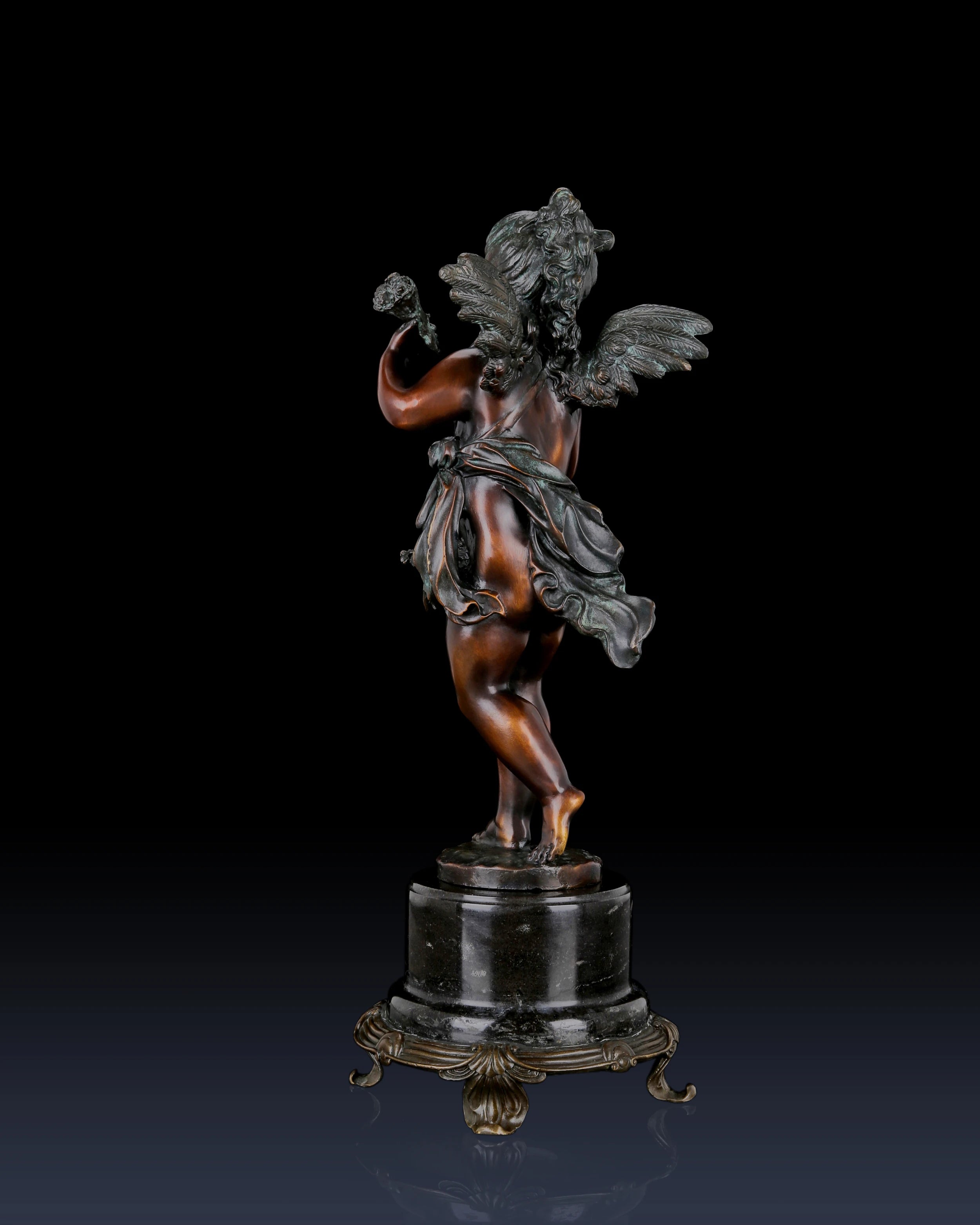 Handcrafted bronze Putto sculpture with classical cherub styling and ornate marble base. Lost-wax cast decorative figure for elegant home décor, galleries, and fine art collections.