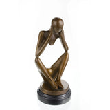 Minimalist abstract bronze sculpture of a seated faceless figure in deep thought, introspective human form statue on black marble base, loss wax casting modern art.