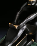 Close-up of stylized bronze sailboat hull with smooth contemporary curves