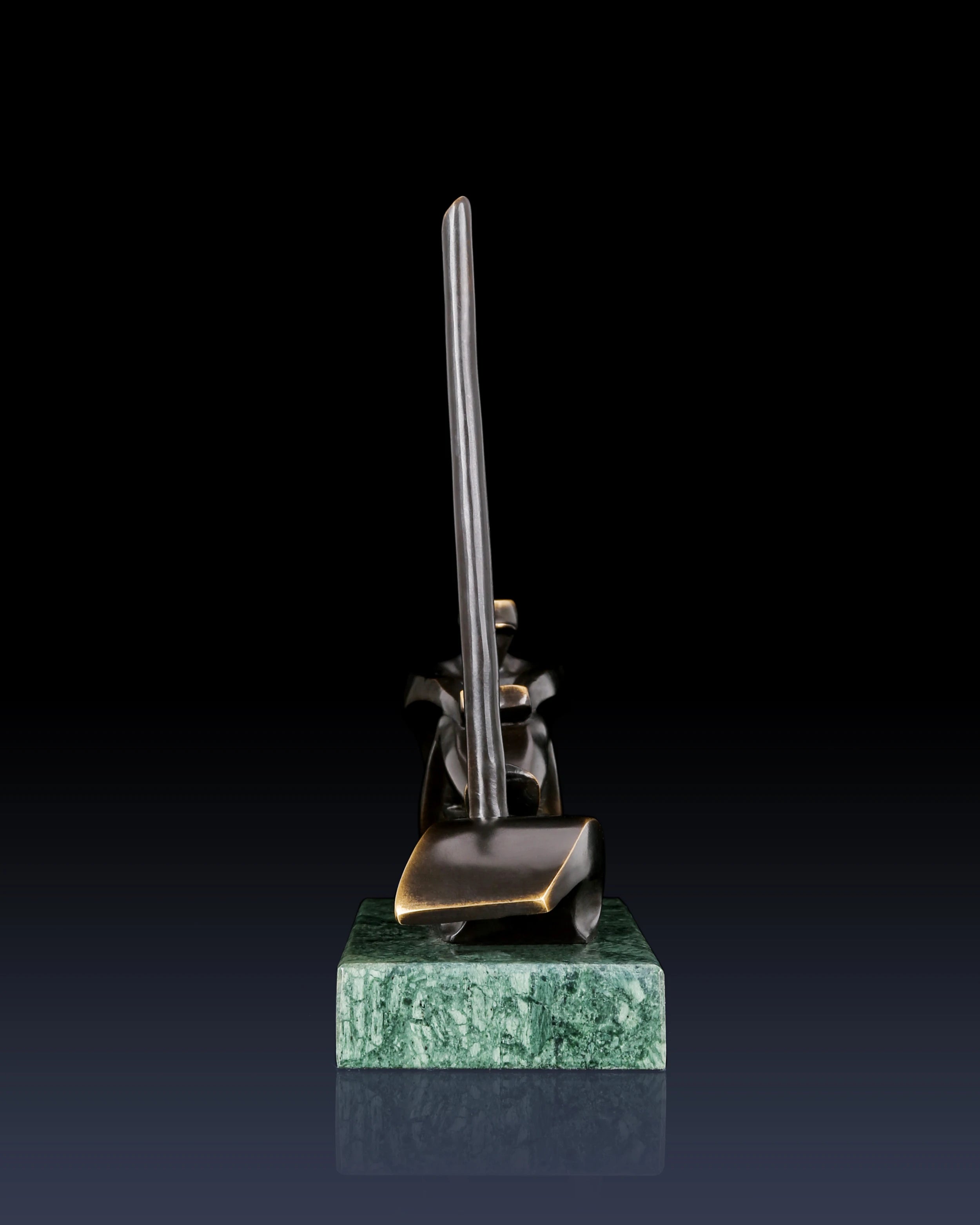 Rear view of abstract bronze sailing sculpture showing minimalist nautical composition