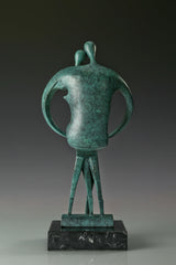 Back view of abstract couple bronze sculpture showing its rounded silhouette and green patina